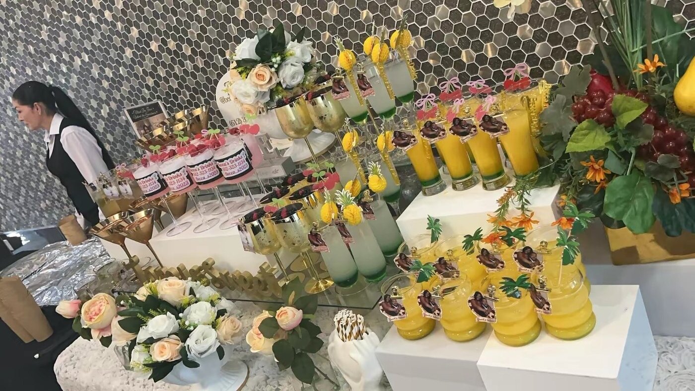 Tropical mocktail display with flowers and fruit